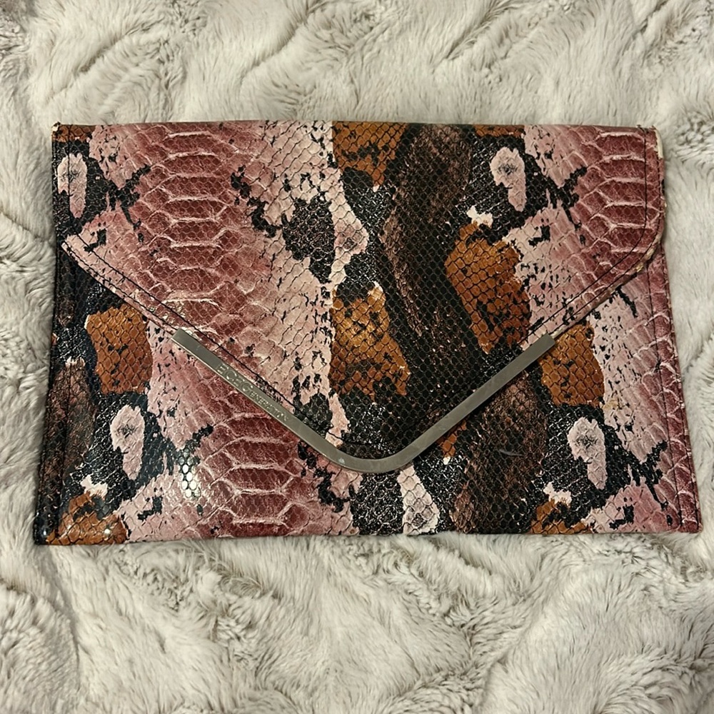 BCBGeneration pink and black snake skin clutch